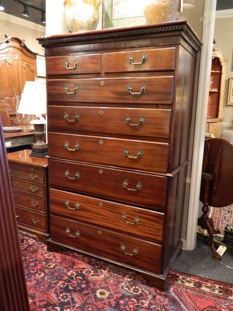 18th Century English Mahogany Tall Chest of Drawers having a dentil molded cornice above a rectangular top two small drawers over six drawers with brass pulls and escutcheons, raised on bracket feet.  Original Pulls