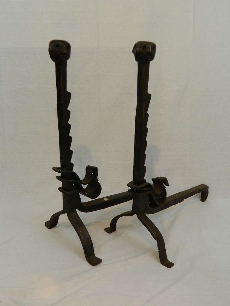 19th century pair of iron andirons or chenets with faces motif.