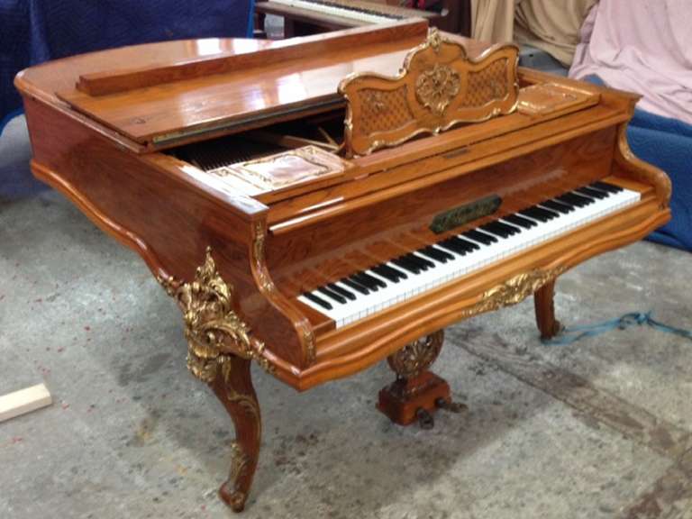 Circa 1910-1920's Belgium J. Gunther Mahogany and Bronze ormolu Baby Grand Piano.  Piano was totally refurbished in 1995.  The firm of J. Gunther was established in Brussels in 1845 by Jacquest-Nicolas Gunther. Gunther's family was third generation