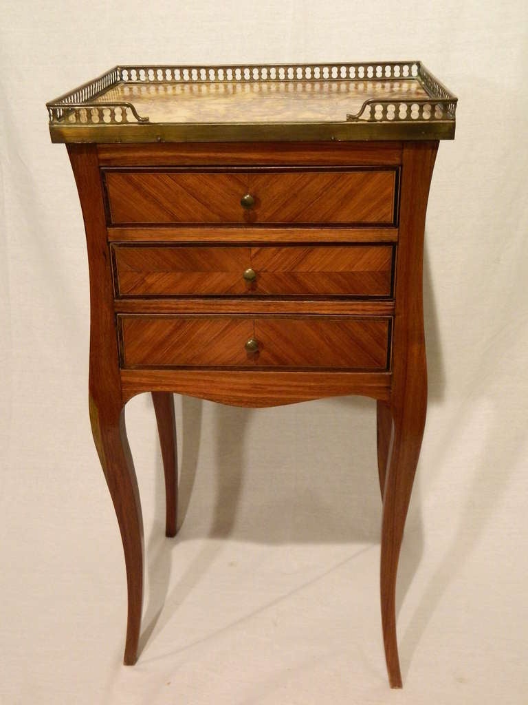 Late 19th century Louis XV style occasional table having a rectangular galleried marble inset top, fitted with three drawers and raised on cabriole legs.