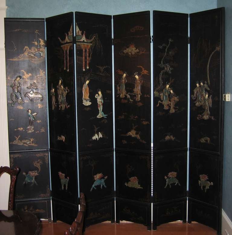 Early 20th Century Twelve Panel Japanese Screen, fabulous one-of-a-kind piece.  Black lacquer background with gilt decoration and applied figures in ivory and soapstone, decorated back.  Each panel is 18