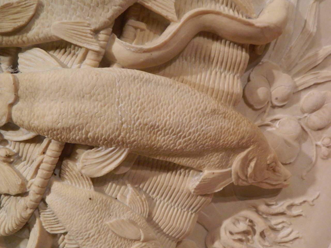 A neoclassical style composition relief wall plaque depicting a trophy with fish, early 20th century.