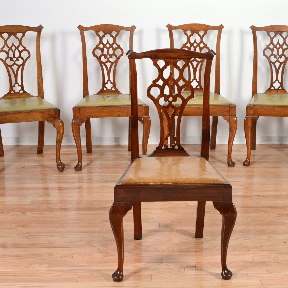 Set of Twelve George III Carved Mahogany Dining Chairs, Early 18th Century.  All side chairs, brown leather slip seats.  Leather seats will be replaced with leather of your color choice at no additional cost