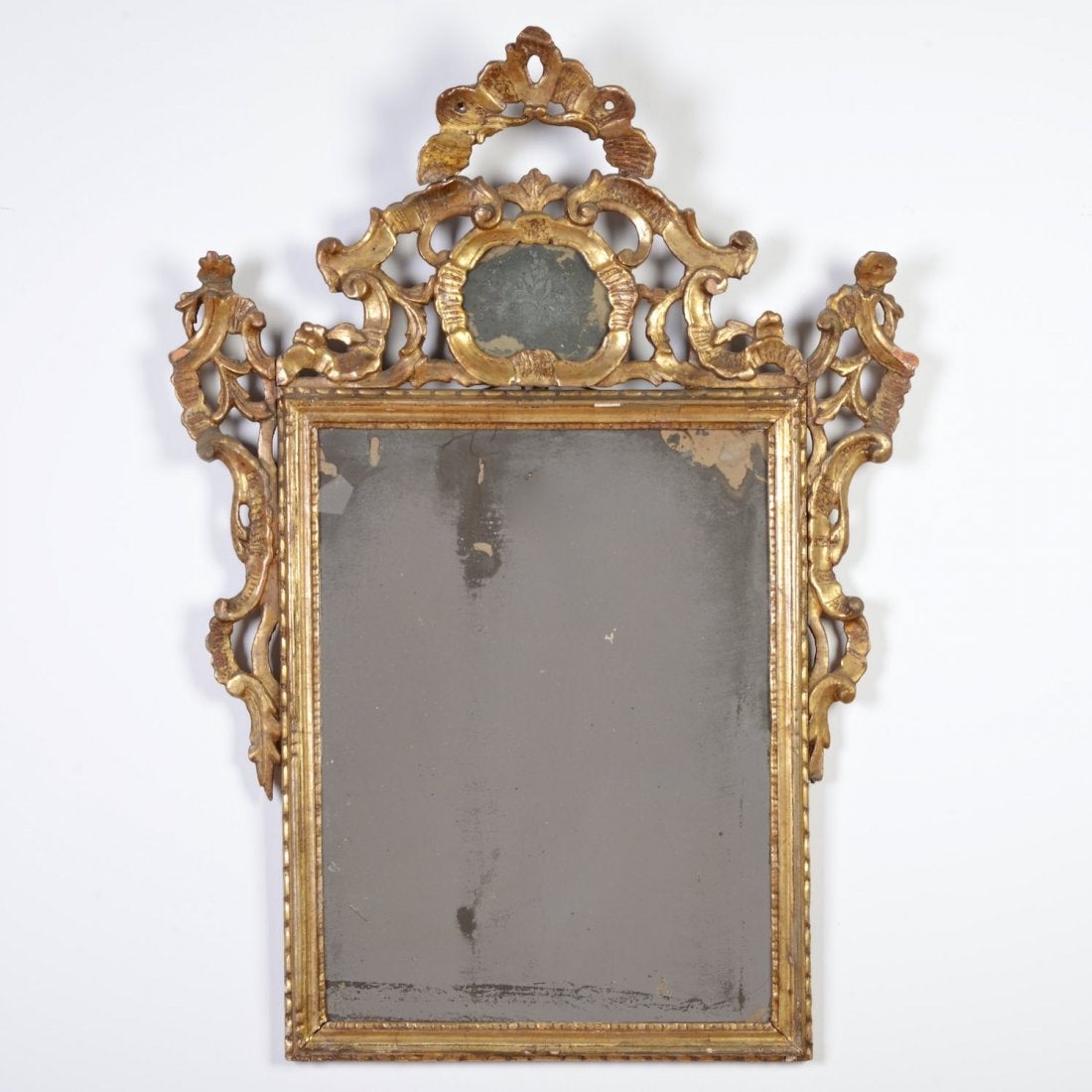 Italian Rococo giltwood wall mirror, 18th century; large open work crest.