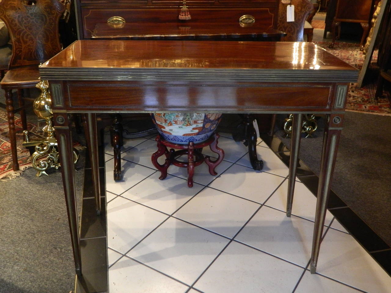 Russian Brass Mounted Mahogany Game Table having a rectangular top opening to square, raised on square tapering legs, 19th Century