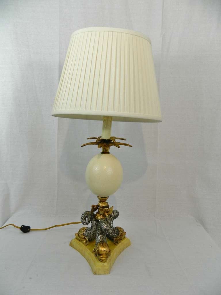 Pair of Gilt Metal Neoclassical Lamps Centered with an Ostrich Egg and Dolphins