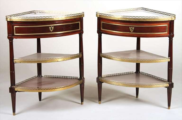 Circa 1780 Pair of Louis XVI Ormolu-Mounted Mahogany Encoignures or Dessert Consoles.  Marble Tops over a Drawer and two Shelves with brass gallery.  Stamped OHNEBERG, Martin Ohneberg  Dimensions:  34 3/4"h x 28"w x 20 1/2"d