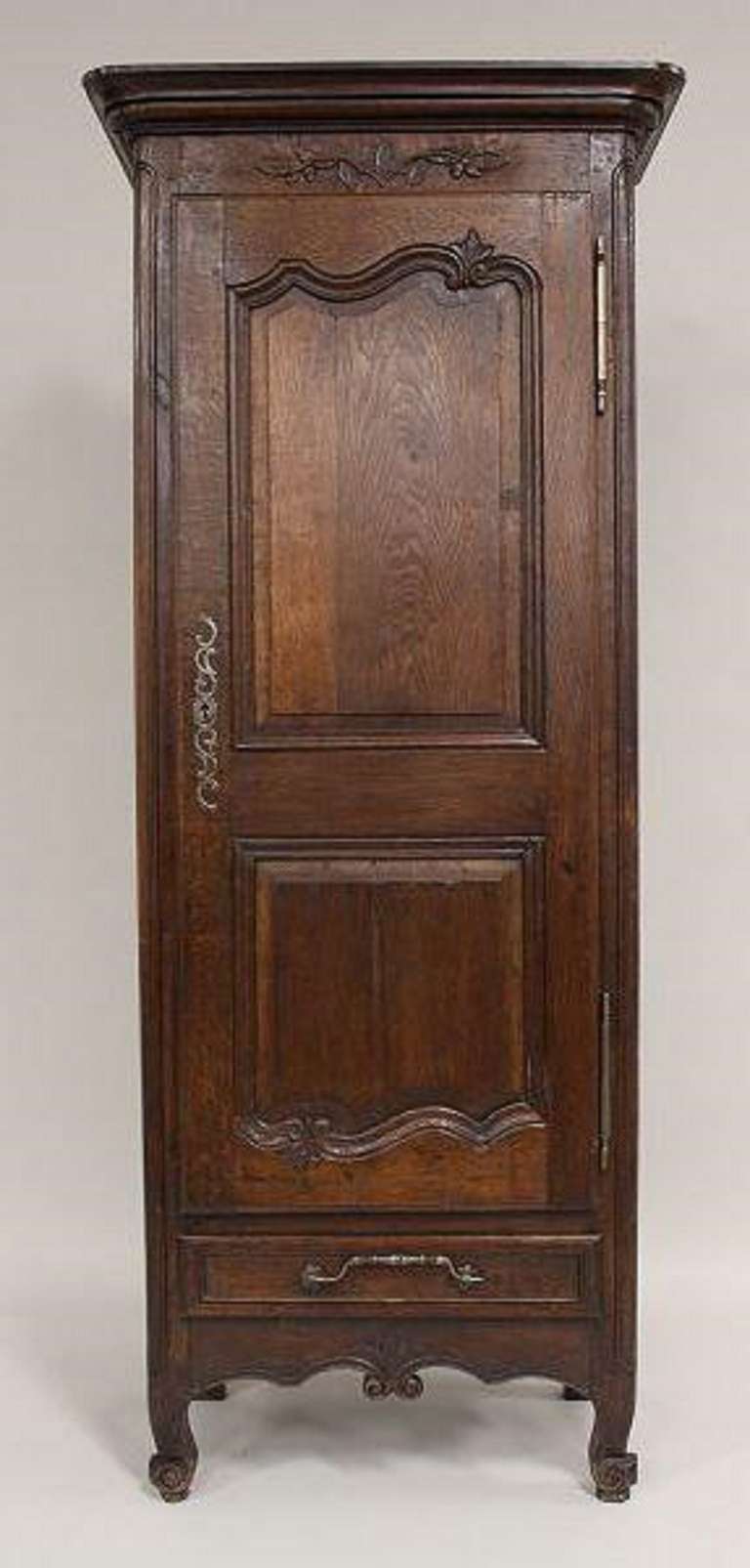 18th Century French Provincial Style Oak Bonnetiere, solid carved door opening to reveal interior fitted for three shelves, above single drawer