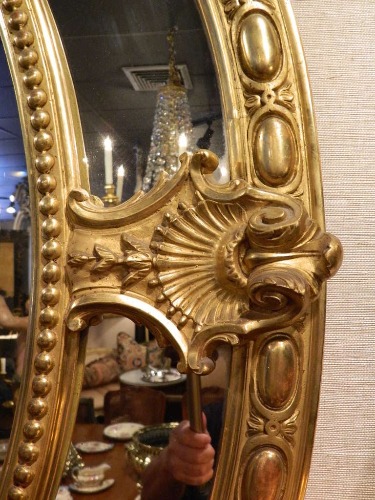 Regency English 24-Karat Water Gilt Oval Mirror Adorned with Cherubs and Shells