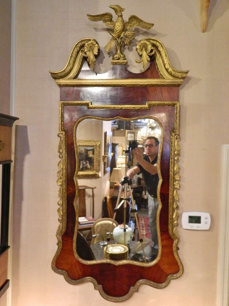19th Century George II Style Mahogany and Parcel-Gilt Mirror with a Gilt Phoenix Finial, the mahogany veneered frame trimmed with molded gilt wood, the sides trimmed with swags of gilt oak leaves and acorns, and the crest having a swan's neck