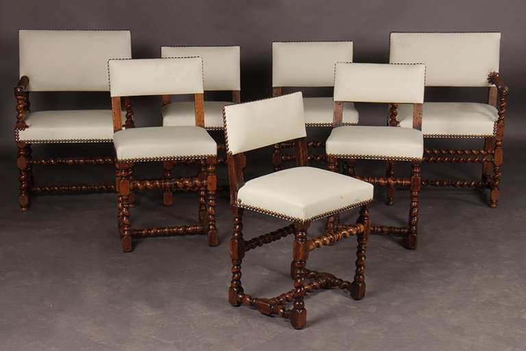 Early 20th Century Set of Twelve English Carved Walnut Chairs Having Barley Twist Arms and Legs with Cross Stretchers.   Set consists of ten side chairs and two arm chairs.  New Upholstery with nail head treatment.

Hostess chair
23.5