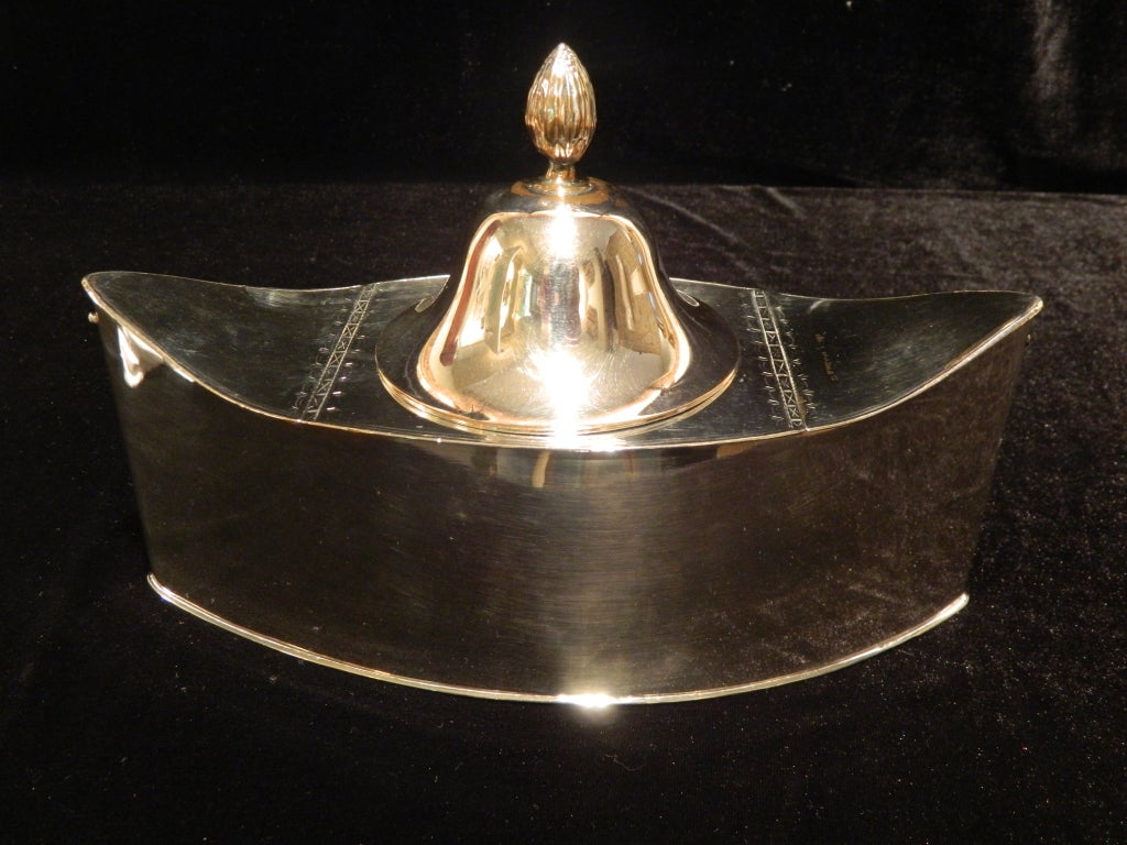 An English silver caviar boat on diminutive square feet, late 19th century. Two slim lids lifting to reveal compartments for ice and a beautiful acorn finial on centre lid.