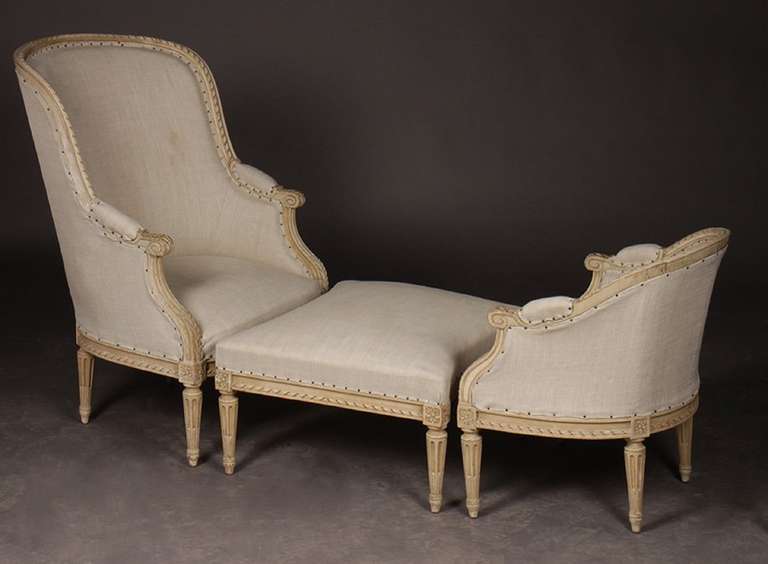 Late 19th Century French Louis XVI Style Carved and Painted Duchesse Brisee having tall bergere, ottoman, and short bergere, all upholstered in linen. Raised on turned and fluted legs