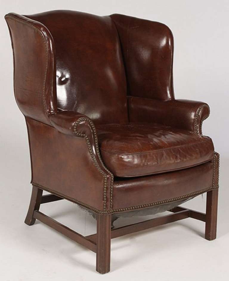 Circa 1920 English Leather Wing Chair with Down Cushion and nail head treatment