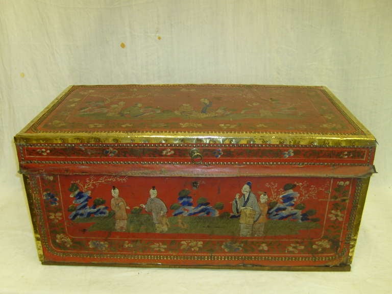 19th century Chinese motif leather and brass bound camphor trunk decorated with domestic scenes, foliate and floral borders with brass studded edges and a handle to each end.
