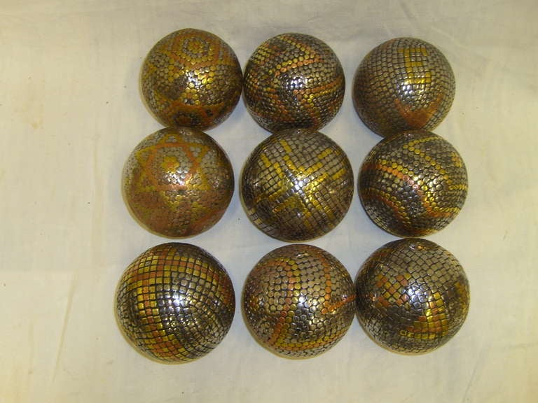 Early 1900's Set of nine boules (petanque) iron, brass, and copper.  A game in which the objective is to throw or roll heavy balls (called boules in France) as close as possible to a small target ball.  Wonderful in a bowl for decoration