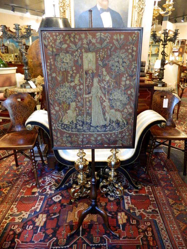 19th Century English Georgian Carved Mahogany Fire Screen Having a Turned Standard and Finial above an Adjustable Tapestry Panel frame, on a turned and carved tripod base ending in paw feet