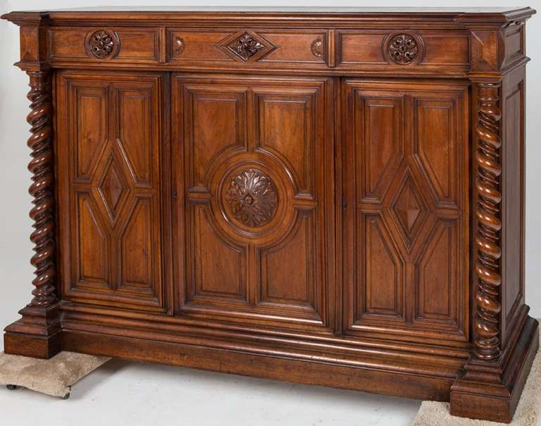 19th Century French Renaissance Style Walnut Sideboard or Side Cabinet,  the rectangular top above three drawers, the sides with slides, over cabinet doors flanked by barley twist supports, on a plinth