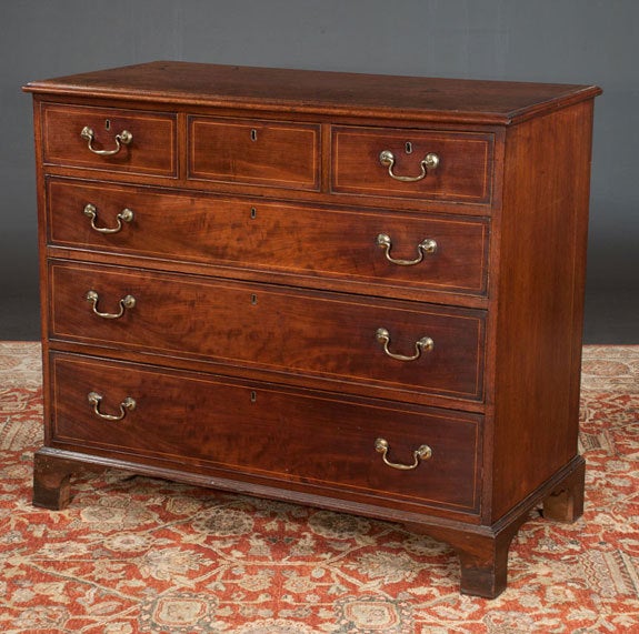 Early 19th century Chippendale mahogany chest with three small drawers over three full graduated drawers and on bracket feet. Original brass hardware.