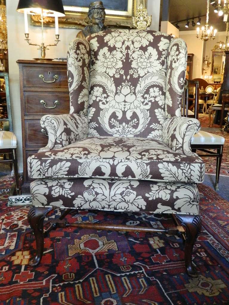 Late 19th Century Chippendale Style Mahogany Upholstered Wing Back Chair with Down Cushion.  The padded rectangular back joined by shaped sides and outscrolled arms to the cushioned seat, raised on cabriole legs headed by shells and ending in padded