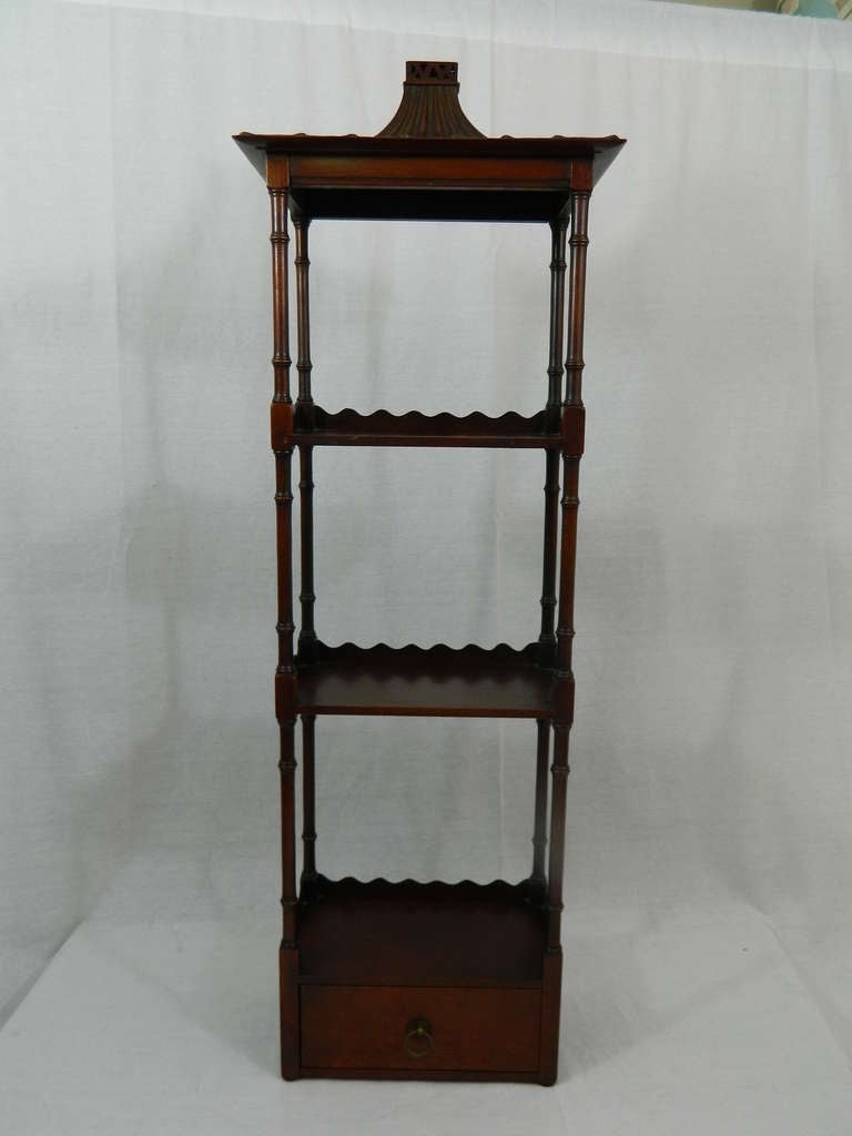 Circa 1950's Pair of Mahogany Chinese Chippendale Pagoda Style Hanging Shelves, Columns Support three shelves above a small drawer with original brass knobs.  Made by Robert W. Irwin Company.  Irwin metal label in drawers