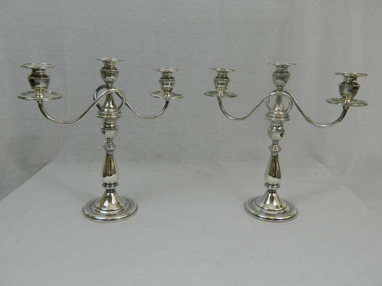 Mid-20th Century Pair of Weighted, Sterling Convertible, Three Light Candelabra, Mueck-Cary Co., Inc., makers, with gadrooned rims, thistle sconces, reeded bypass candle arms, tapering cylindrical stem and domed foot