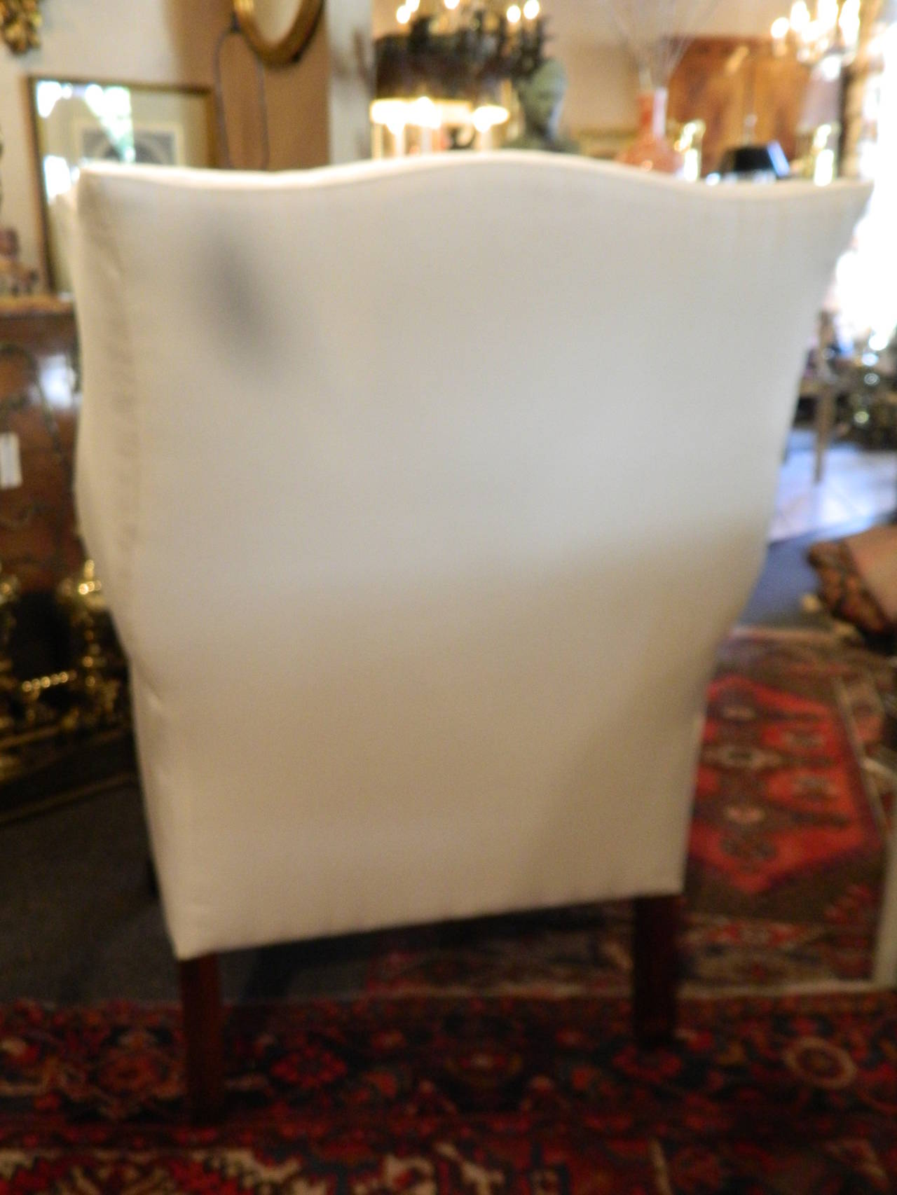 Chippendale style mahogany wingback chair, Early 20th century. Newly upholstered in white muslin. Down cushion.