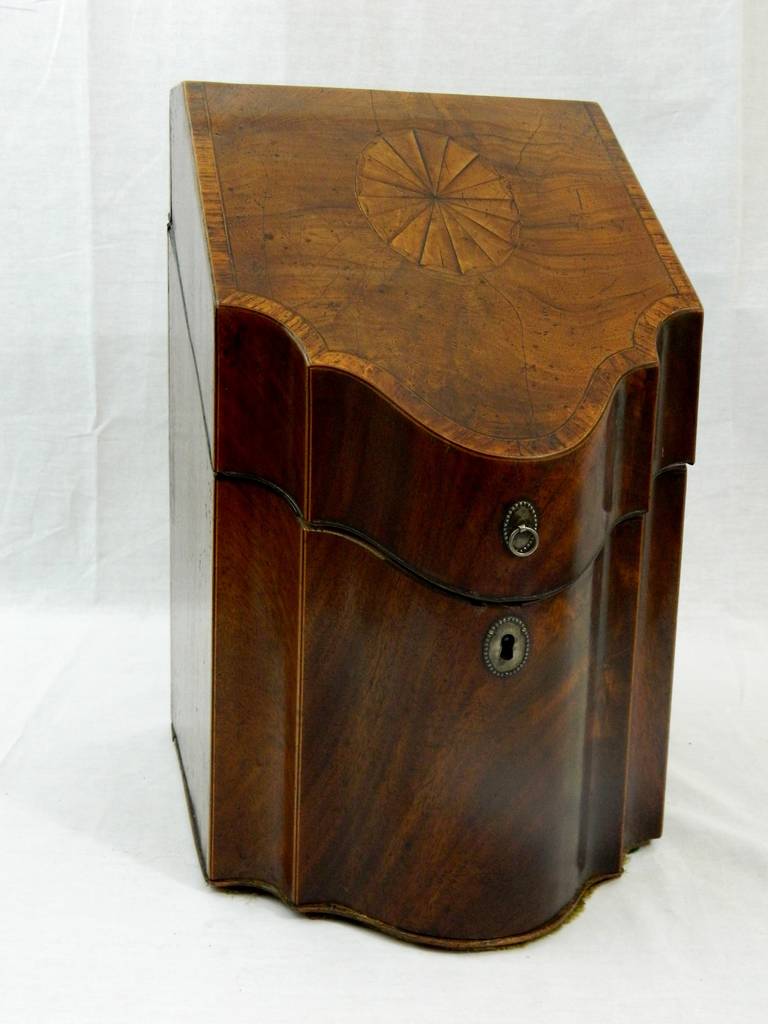 18th century George III inlaid mahogany, rosewood, burl, and ebony knife box. The lid of the knife box inlaid with a sunburst star. Interior is fabric upholstered.