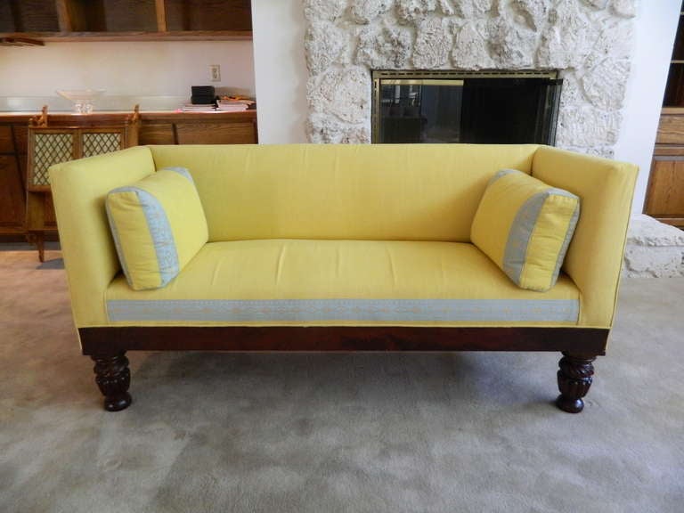 19th century classical box settee or sofa with mahogany apron and carved melon feet.