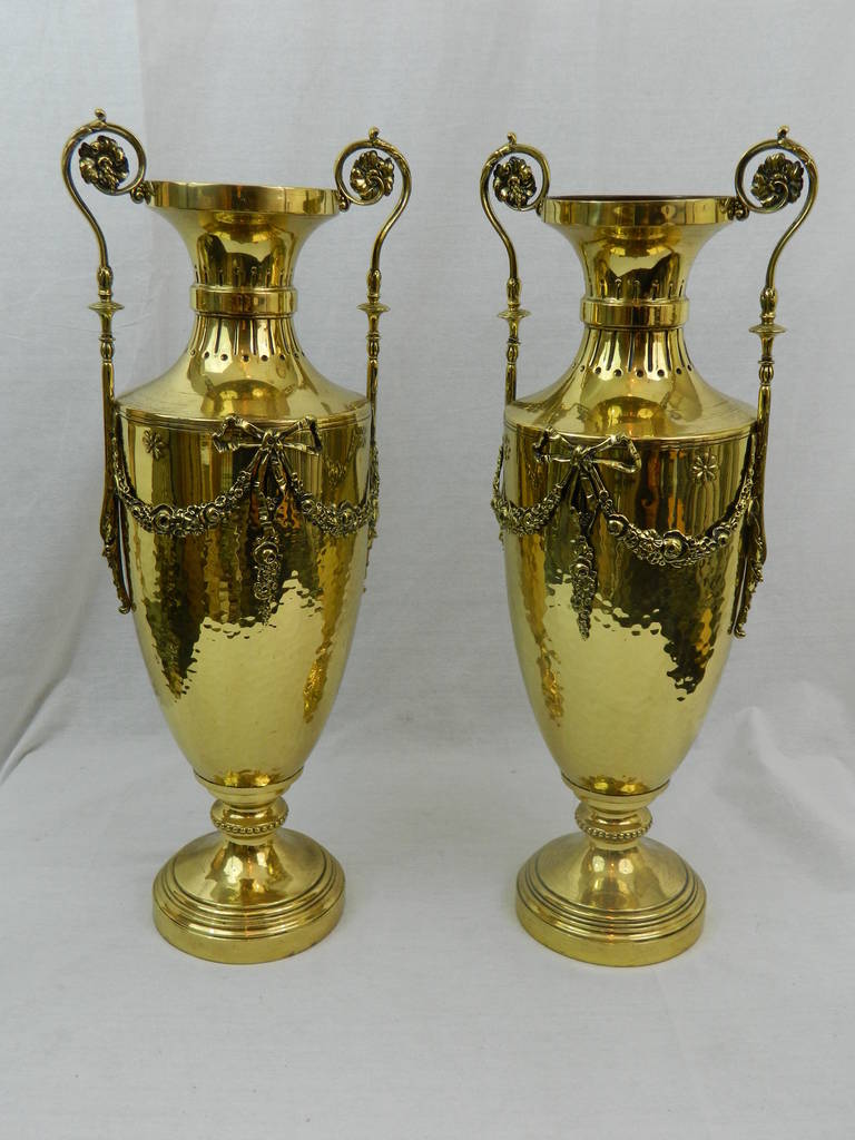 19th century pair of polished brass decorative urns or vases with handles.