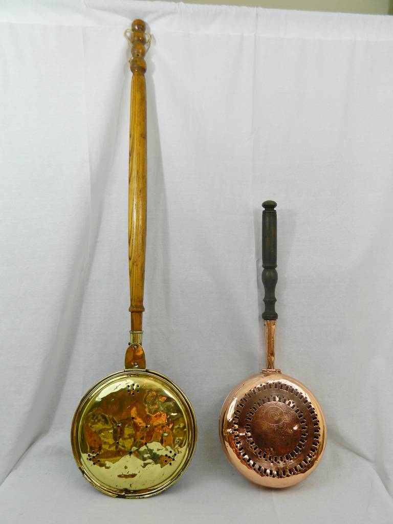 Late 18th century brass or copper bed warmers with great patina wood handles. They are great for hanging on the wall or next to a fireplace.
Measures:
Brass bed warmer: 46