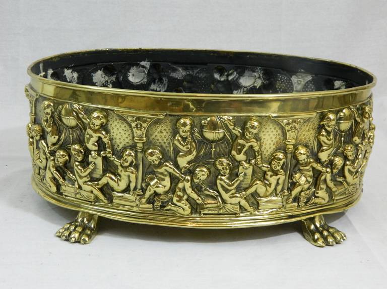 19th Century French Polished Brass Jardiniere or Oval Planter on Feet.  Cherubs scene throughout