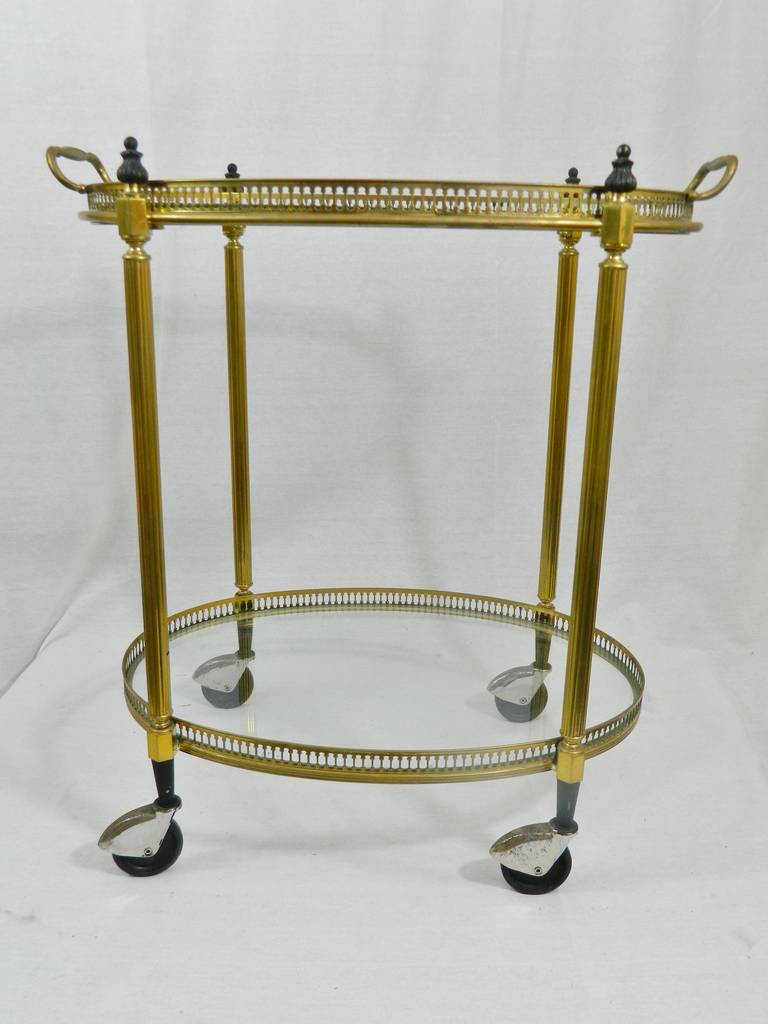 French polished brass and glass drinks cart or trolley with removable trays for serving. Black decorative finials, circa 1920s.