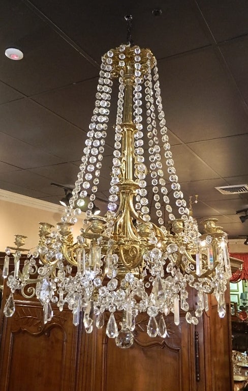 French Bronze Dore Eighteen Candle Chandelier with Strands of Crystal, 19th Century.  Includes a Bronze Dore Canopy.  Not Electrified but can be at no additional cost