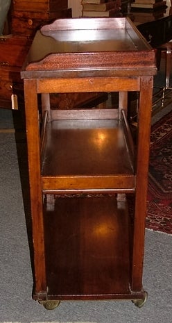 English Mahogany Three-Tier Serving Cart or Trolley Server;
three moulded galley shelves and resting on rolling brass casters