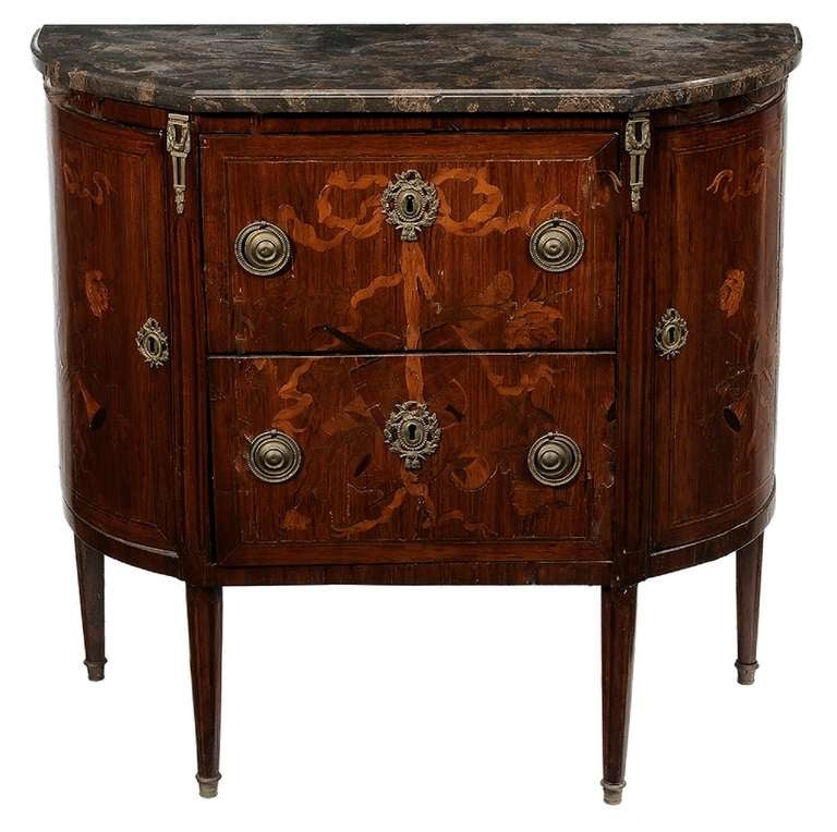 19th Century Louis XVI Style Marquetry Inlaid Marble Top Commode or Chest of drawers flanked by two cabinet doors, ribbon inlays with marquetry musical trophies