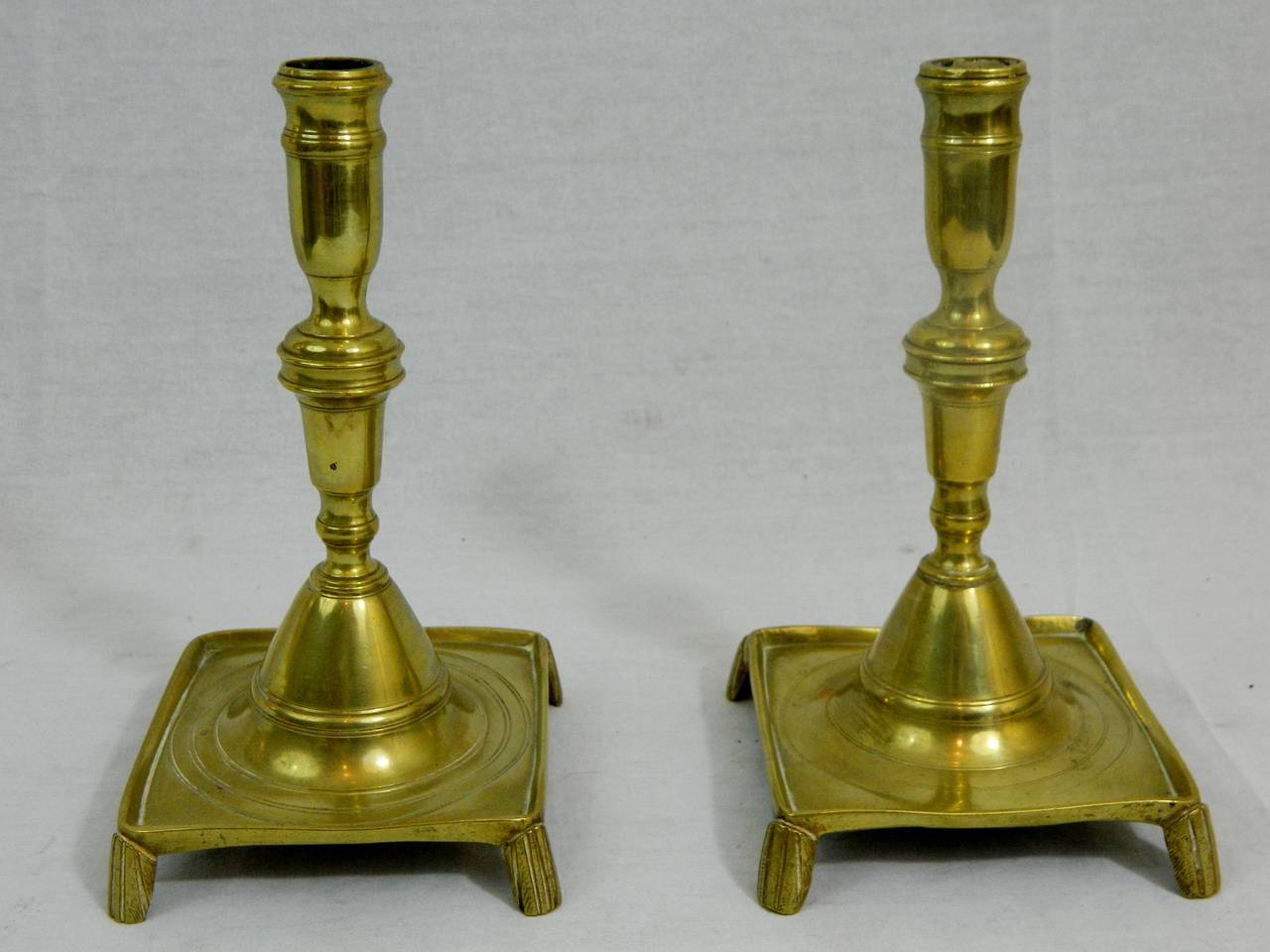 18th century pair of French brass candlesticks with square bases.