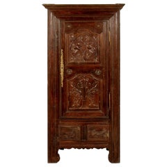 A French Oak Bonnetiere with Carved Door, Early 19th Century