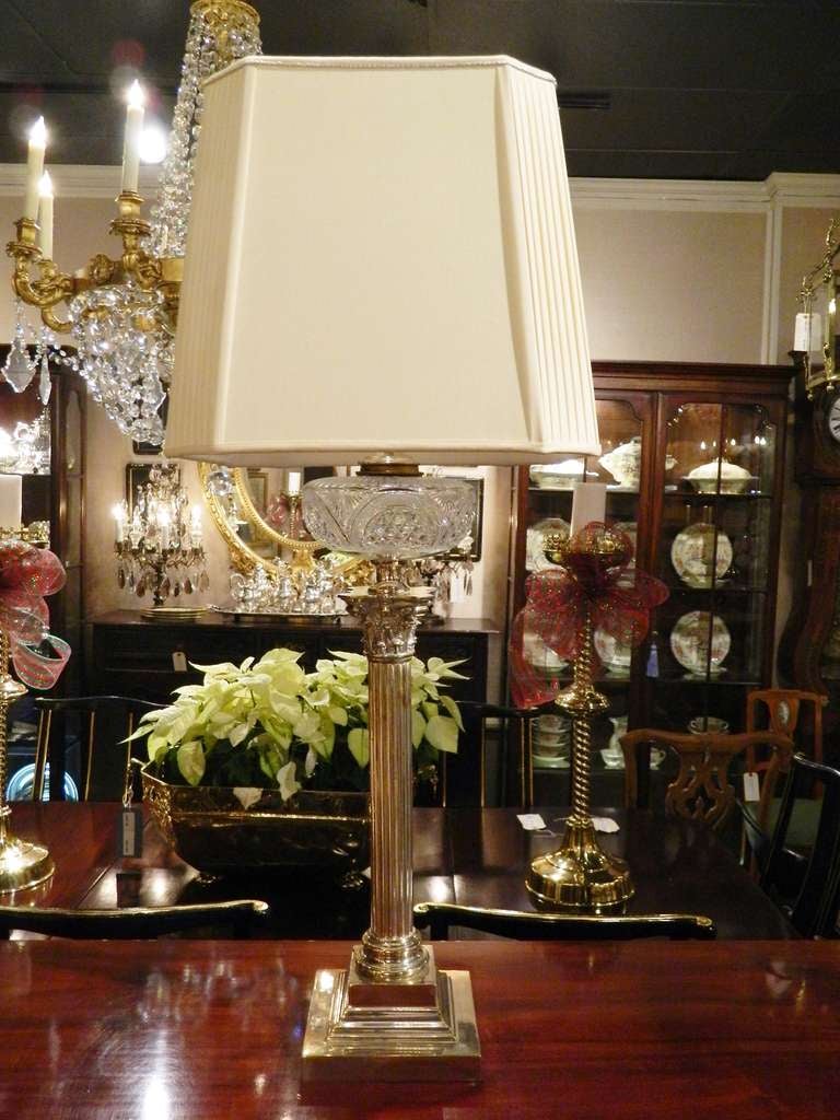 Early 20th century electrified silver Corinthian column oil lamp with a crystal dispenser and a custom made silk shade.