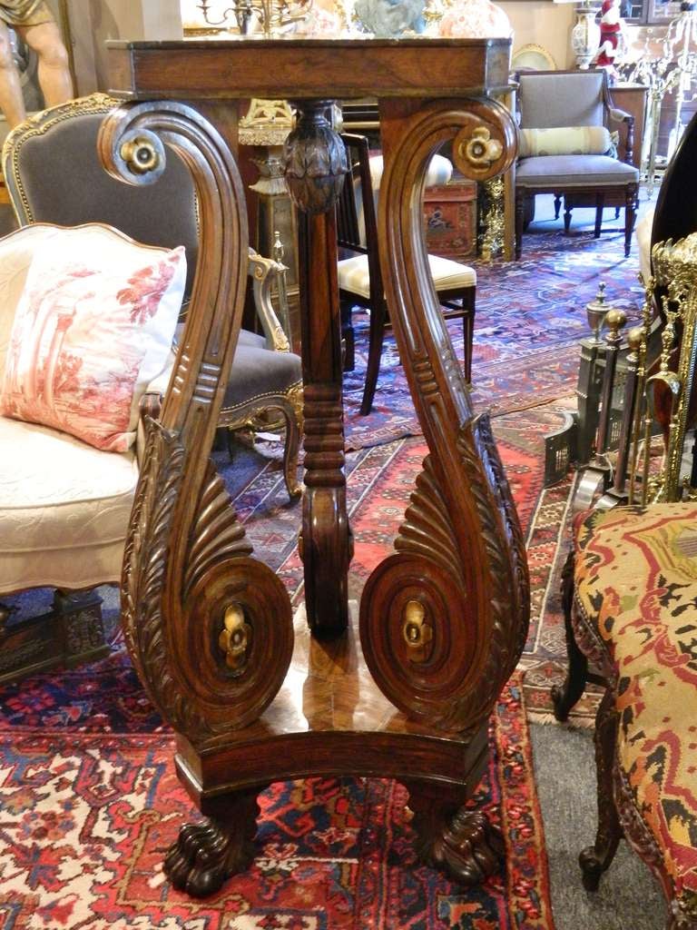 19th century rosewood Regency torchere or pedestal on three carved legs and gold leaf decorations.
