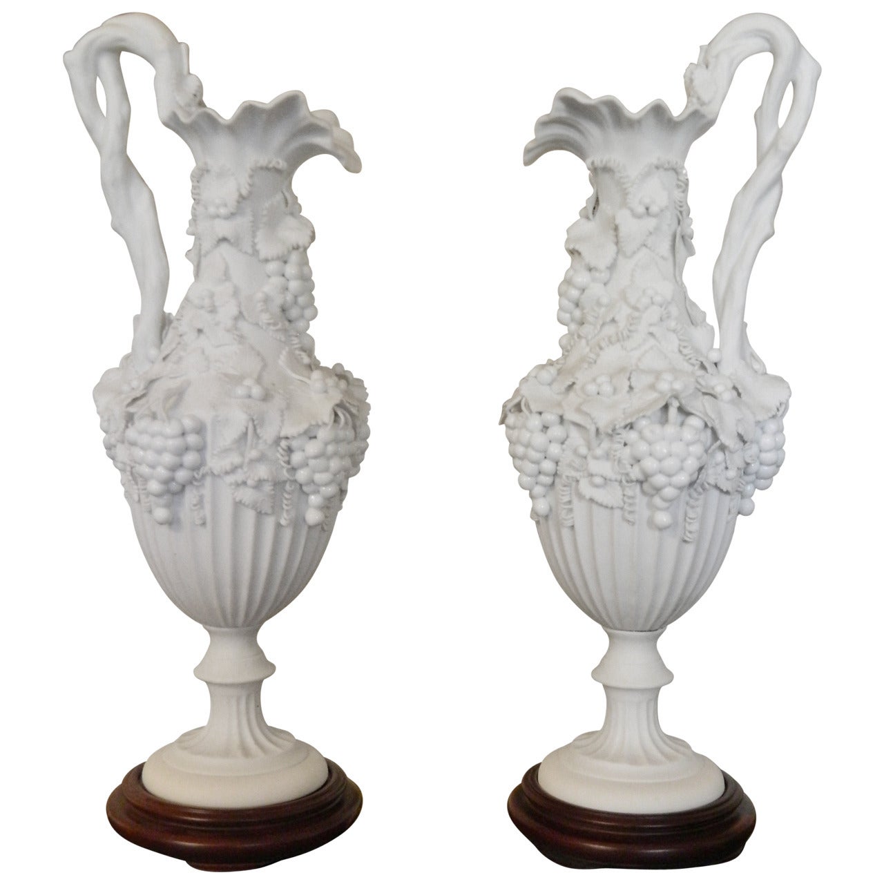 Pair of White Bisque Porcelain Urns with Handles and Fruit Relief