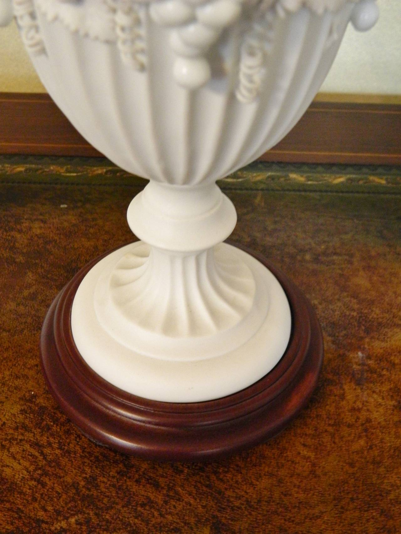 Pair of White Bisque Porcelain Urns with Handles and Fruit Relief