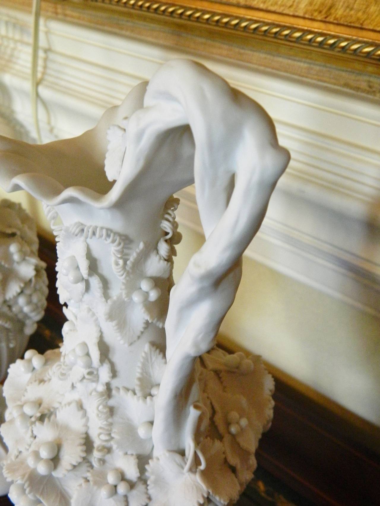 Pair of White Bisque Porcelain Urns with Handles and Fruit Relief