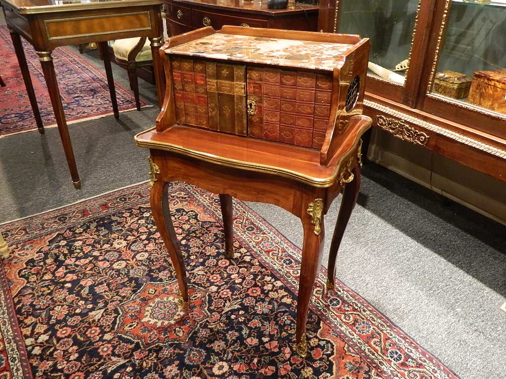 Louis XV side table with inlaid old spine book fronts, marble-top, 19th century. Side drawer fitted as a lap desk that includes bronze doré Inkwell; Raised on fine cabriole legs. Bronze doré handle and fittings. The sides have quatrefoil openings
