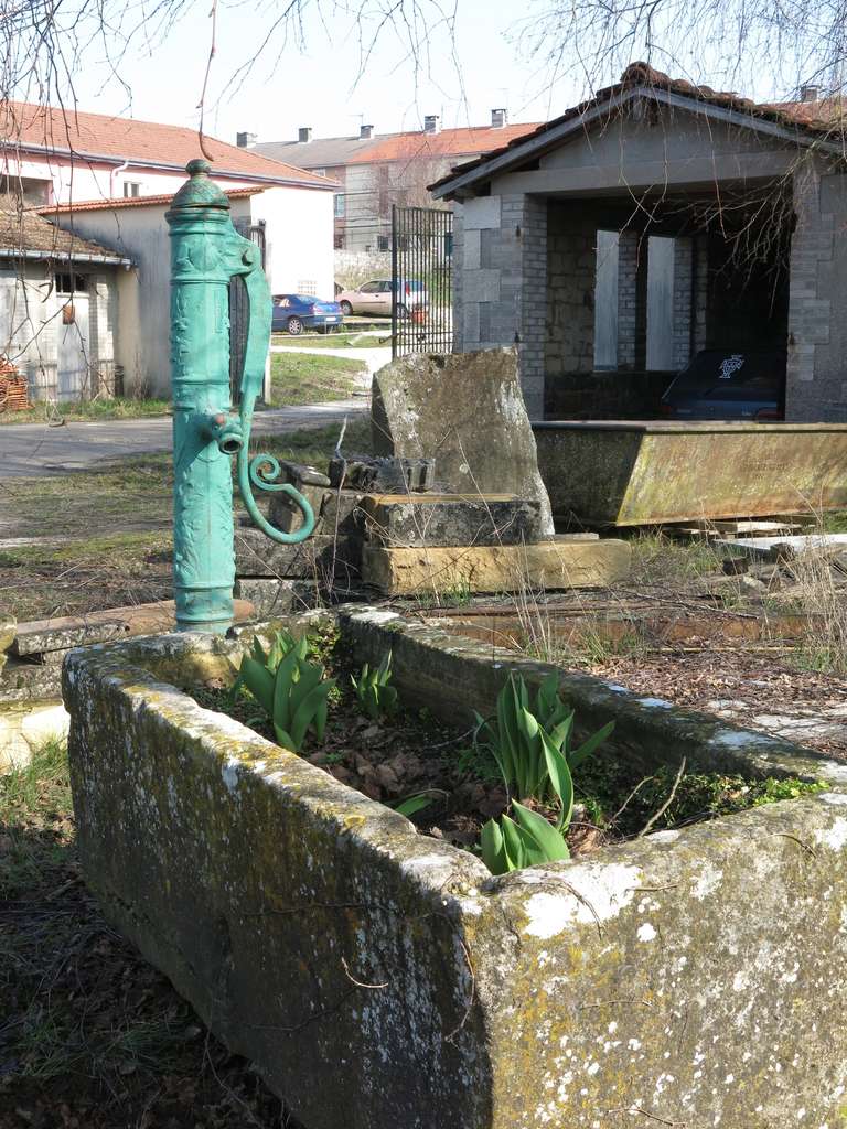 Rustic French Village Limestone Water Fountain with Iron Water Pump, France, circa 1800 For Sale