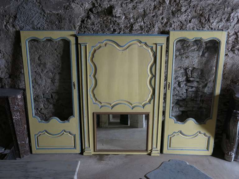 A French Louis XV style paneling parts handcrafted (wood) 19th century from France.
This set is composed of two sides doors with window and one top of a fireplace with mirror called 