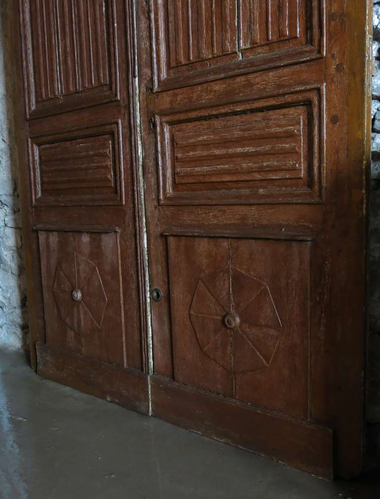 A rare pair of Main-Entrance-Doors from a French Abbey Louis XIII style.
In Oak (wood) handcrafted circa 1700s from France.

Original painting on both doors with original patina.

The upper-panels are sculpted as "plis de serviettes"