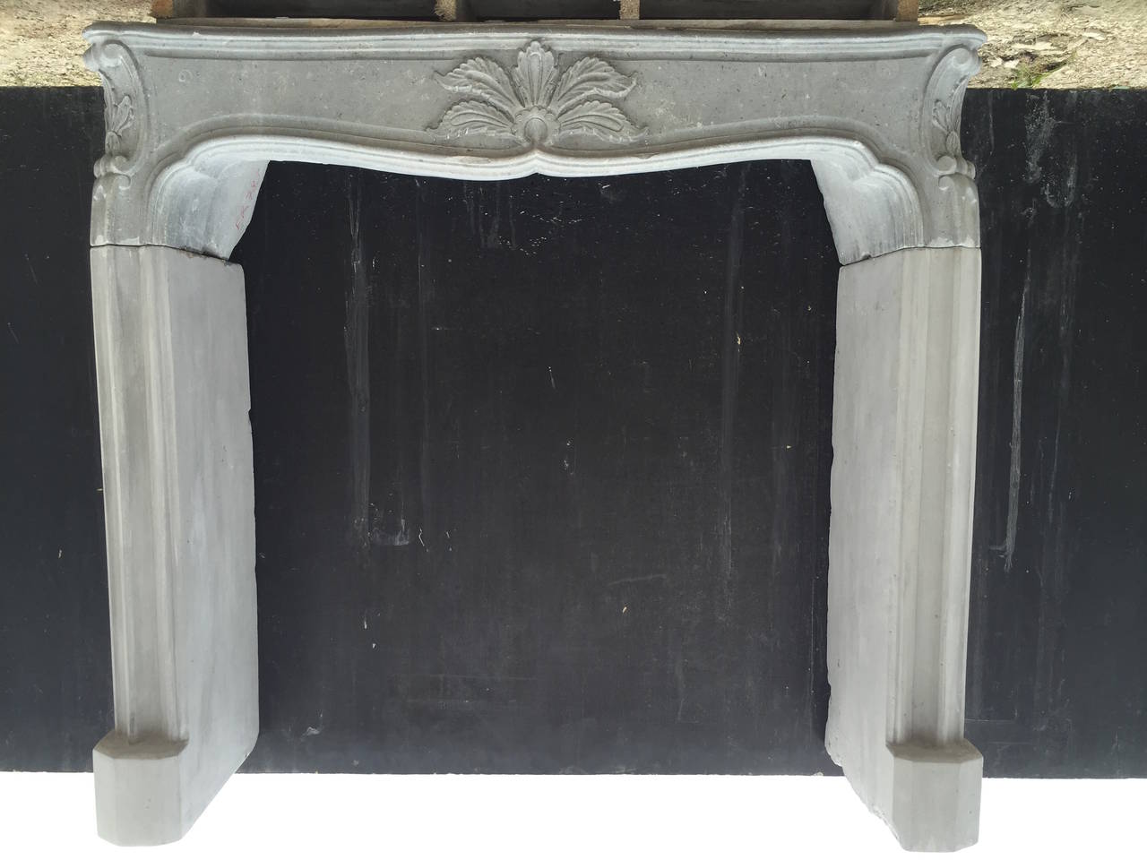 A French Louis XV style fireplace hand carved in stone from France. Restored perfectly.
Beautiful quality of French Art Work from that period.
Great flower and design hand carved on the middle and sides of the mantel.
Legs have been restored