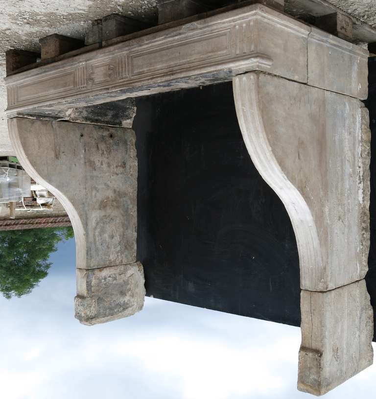 Original French Louis XVI Period Fireplace Handcrafted In Limestone Circa 1770s From France. Very good quality of limestone from Lorraine, North-East of France.

Curved and carved legs, with flutings all way long and on the mantel.
Beautiful
