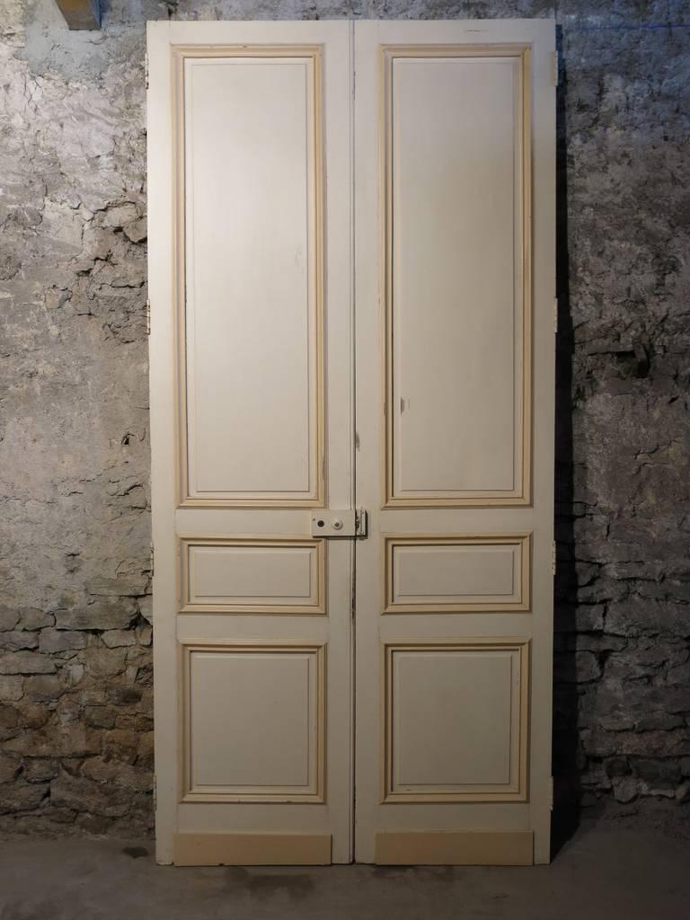 A large and monumental Louis XIII style double faces doors in wood, handcrafted circa 1800s in Paris, France. Very good quality of work on each side of each door (double faces). Doors called 